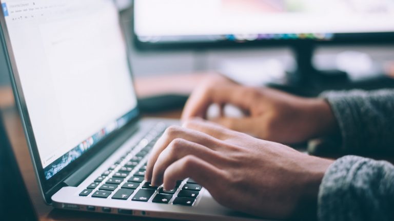 Man typing on laptop